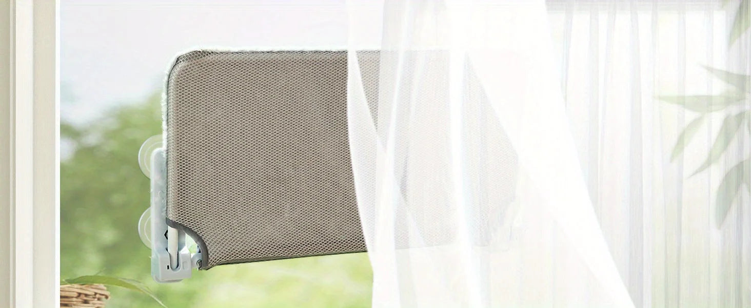 A cat hammock secured on the window using suction cups, providing a perfect spot for cats to relax