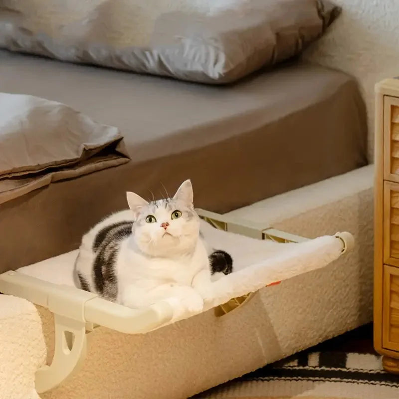 Window Bed for Cats, a comfy cat hammock positioned near a bed, perfect for your pet to relax and enjoy the view.