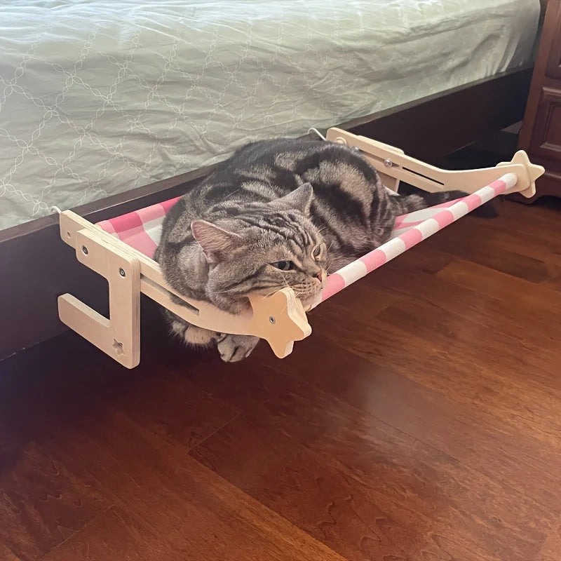 A comfortable Snuggle Cat Bed Nest with a pink striped design, offering a cozy resting place for your furry friend under the bed.