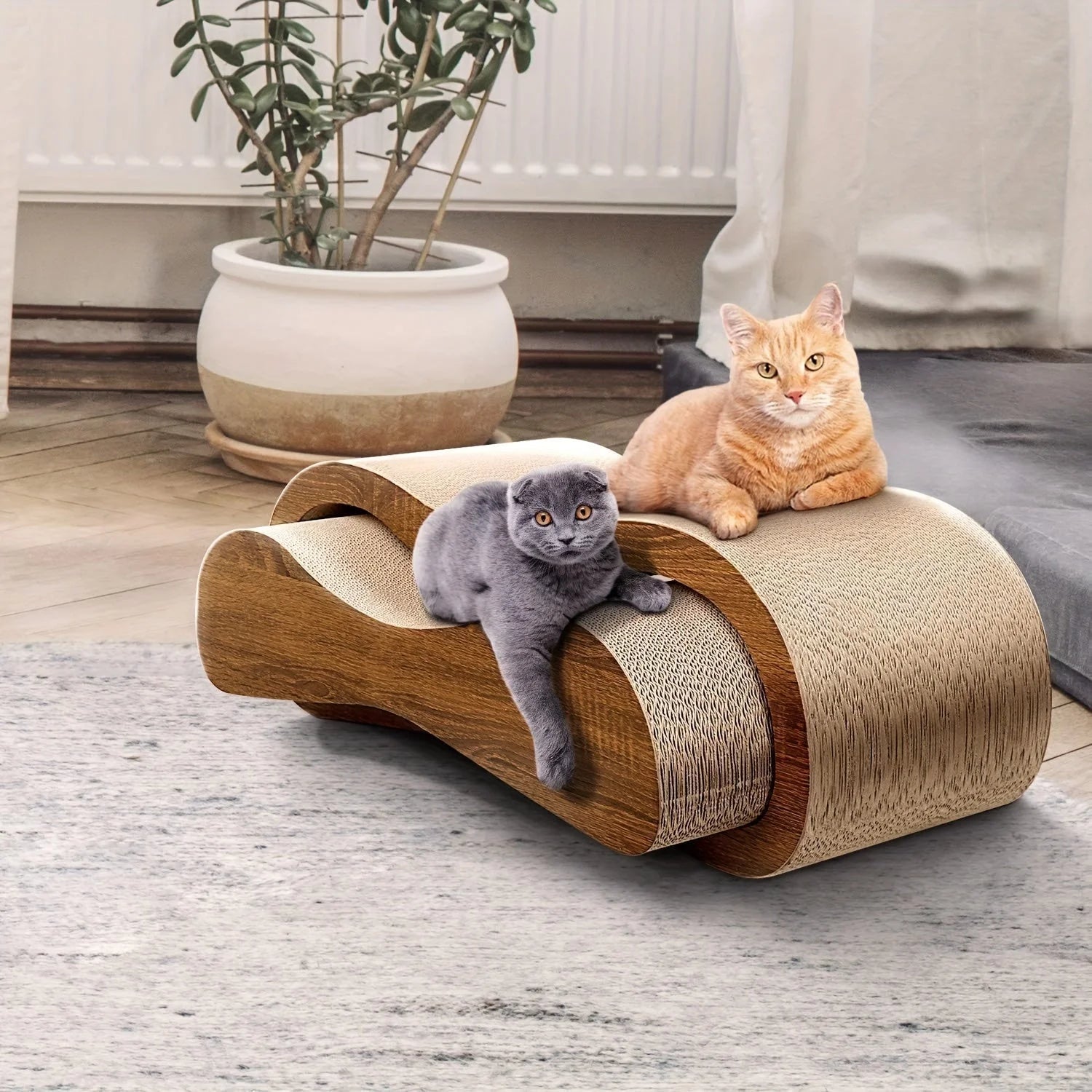 Two cats comfortably lounging on curved cardboard cat scratchers designed for relaxation and scratching.