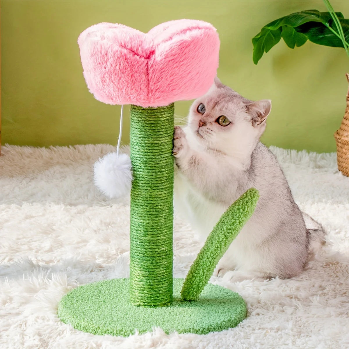 Cat actively scratching the green sisal-covered post of a DIY pink flower cat scratching post.