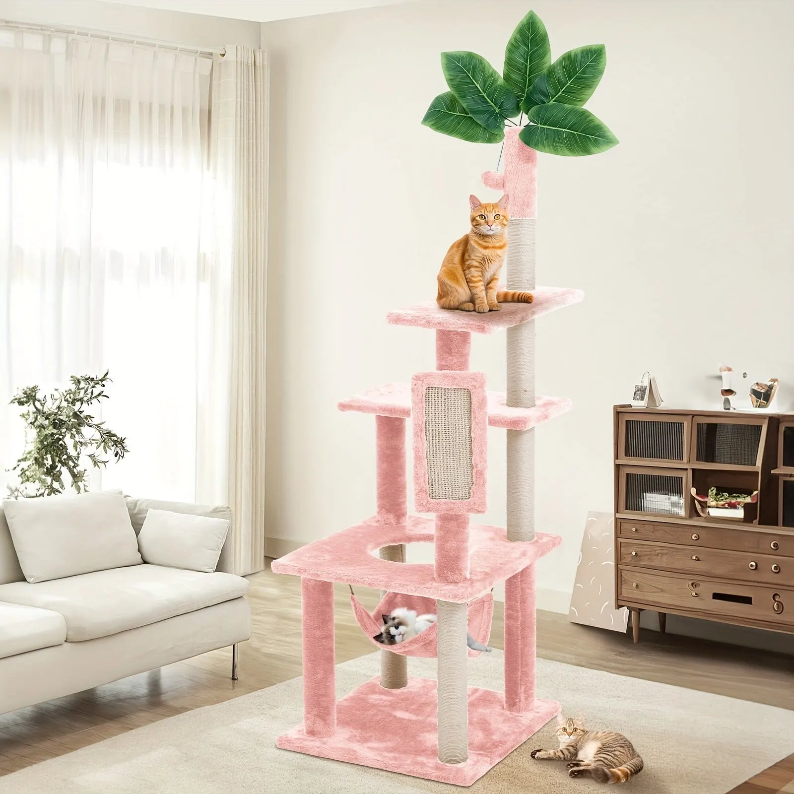 "Pink cat tower for large cats, featuring multiple platforms, a hammock, and a leafy design for playful felines."