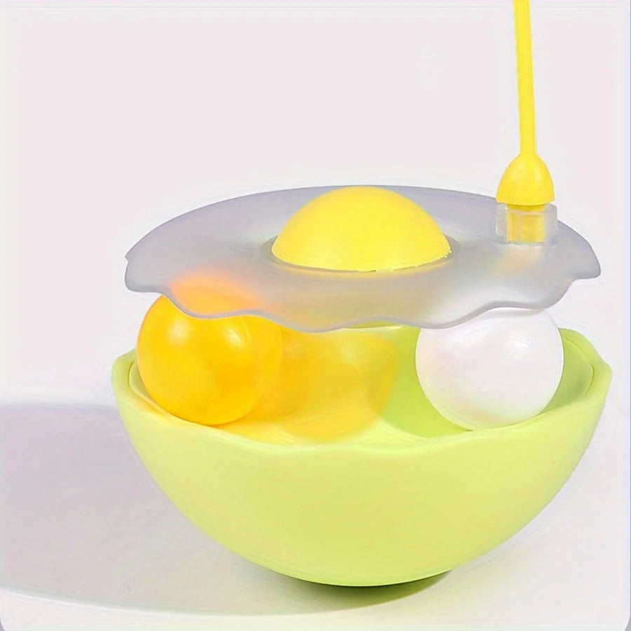 Close-up shot of a yellow cat toy feather wand with balls inside, showing the feather attachment.
