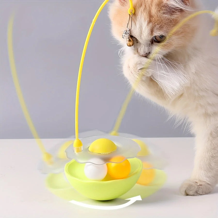 A cat playing with a yellow cat toy feather wand as it swings, with motion blur showing its movement.