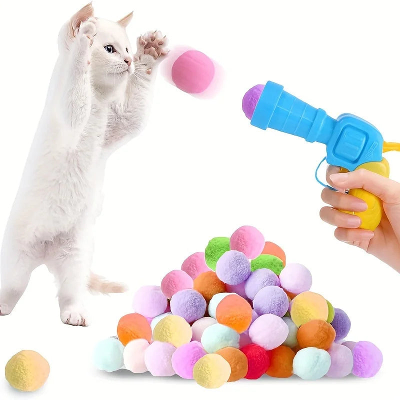 White cat jumping to catch a launched pom-pom from the cat toys for kittens set.