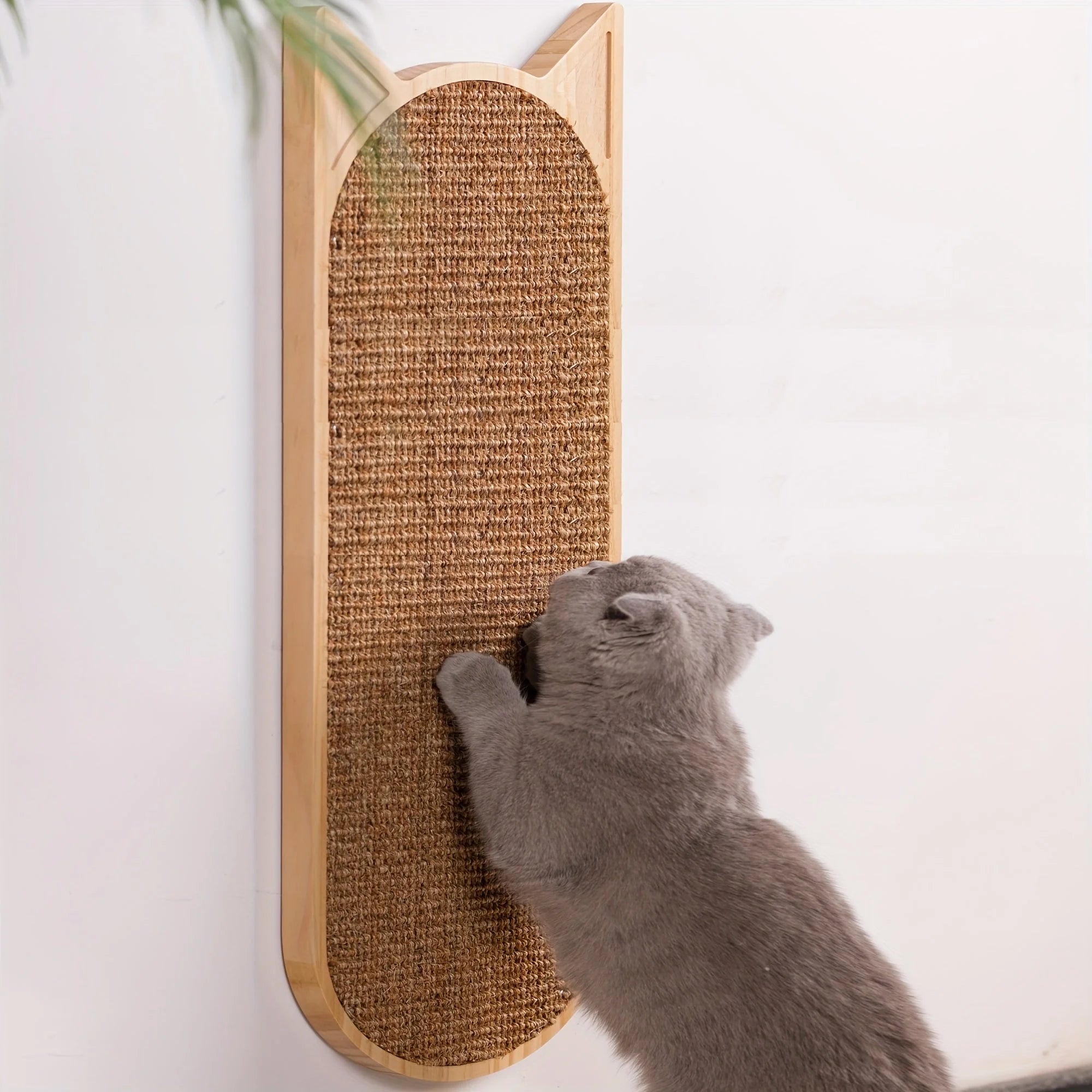 Gray cat scratching a vertically mounted cat wall scratching post with a natural sisal surface and wooden frame.