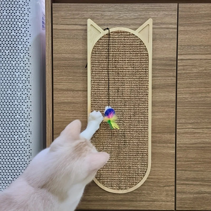 White cat playing with a colorful hanging toy attached to a cat wall scratching post mounted on a wooden cabinet.