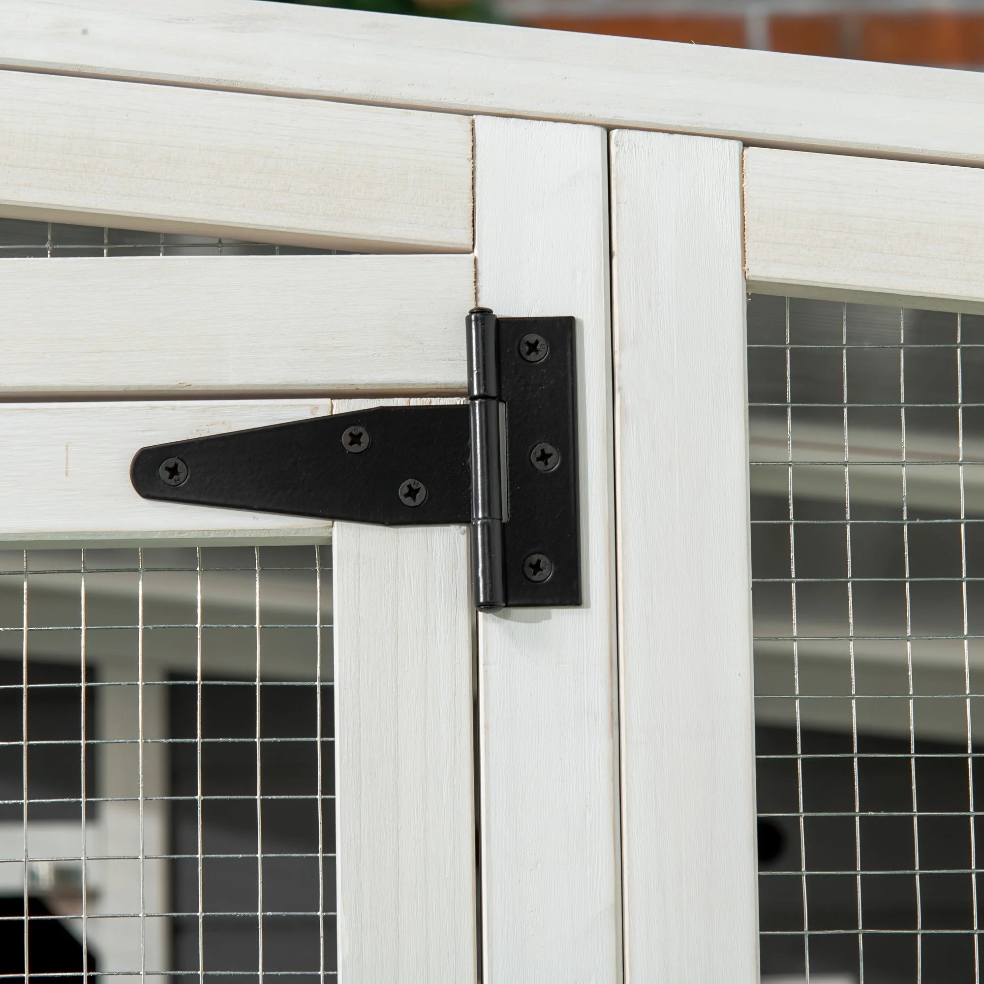 Durable door hinge on an outdoor cat cage enclosure for secure and long-lasting use.