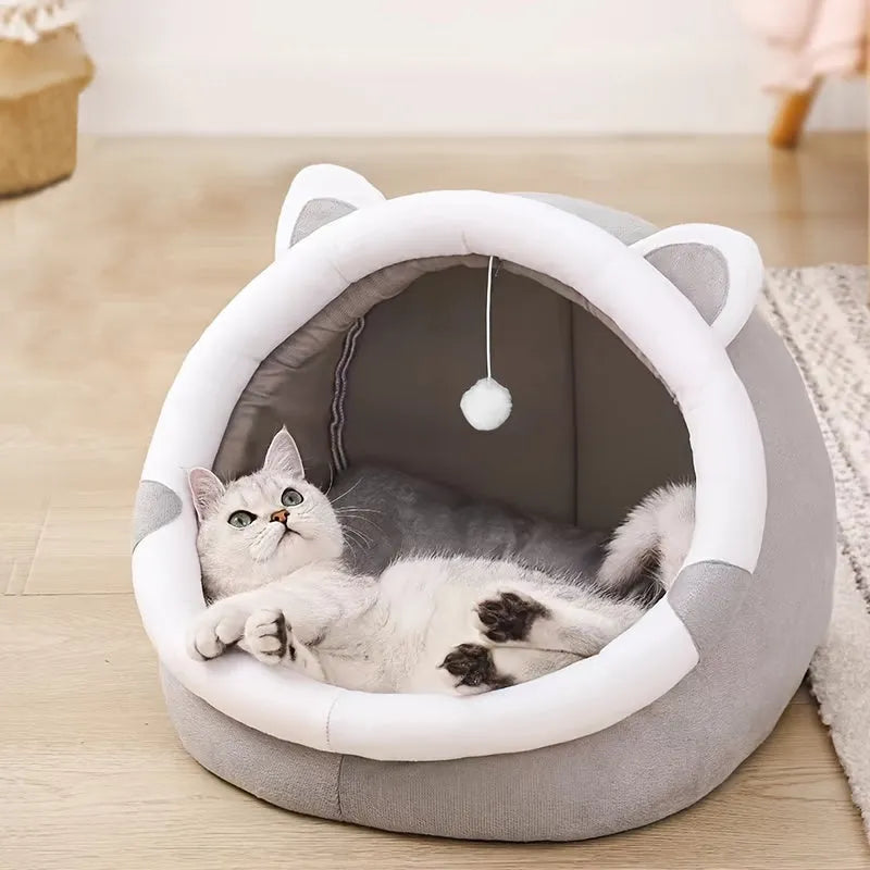 A green enclosed cat bed with a floral-inspired design and a cozy interior for cats to relax.