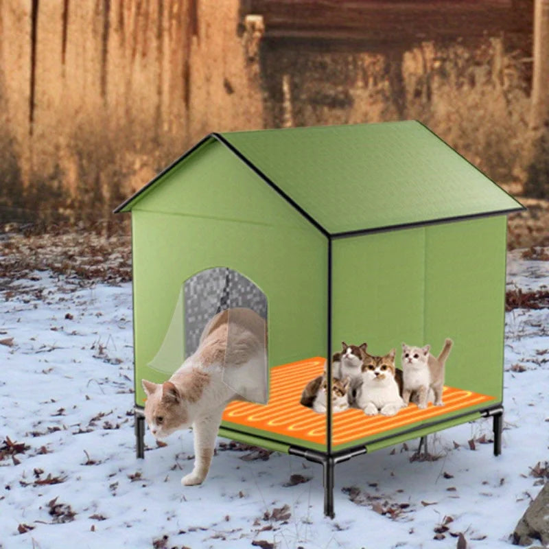 A green heated outdoor house for cats, featuring multiple cats comfortably resting on a warm bed.