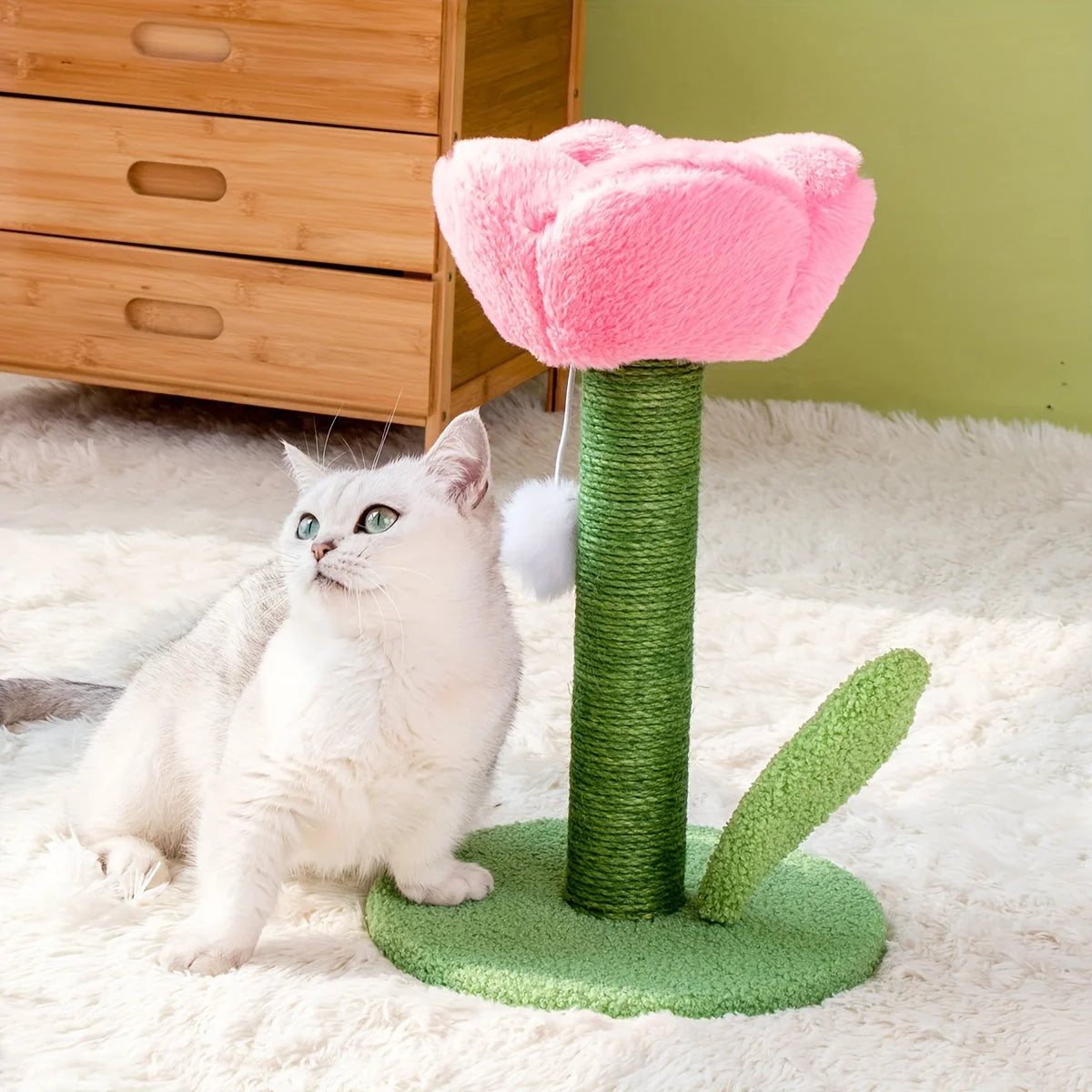 Cat sitting beside a pink flower DIY cat scratching post, ideal for playtime and scratching.
