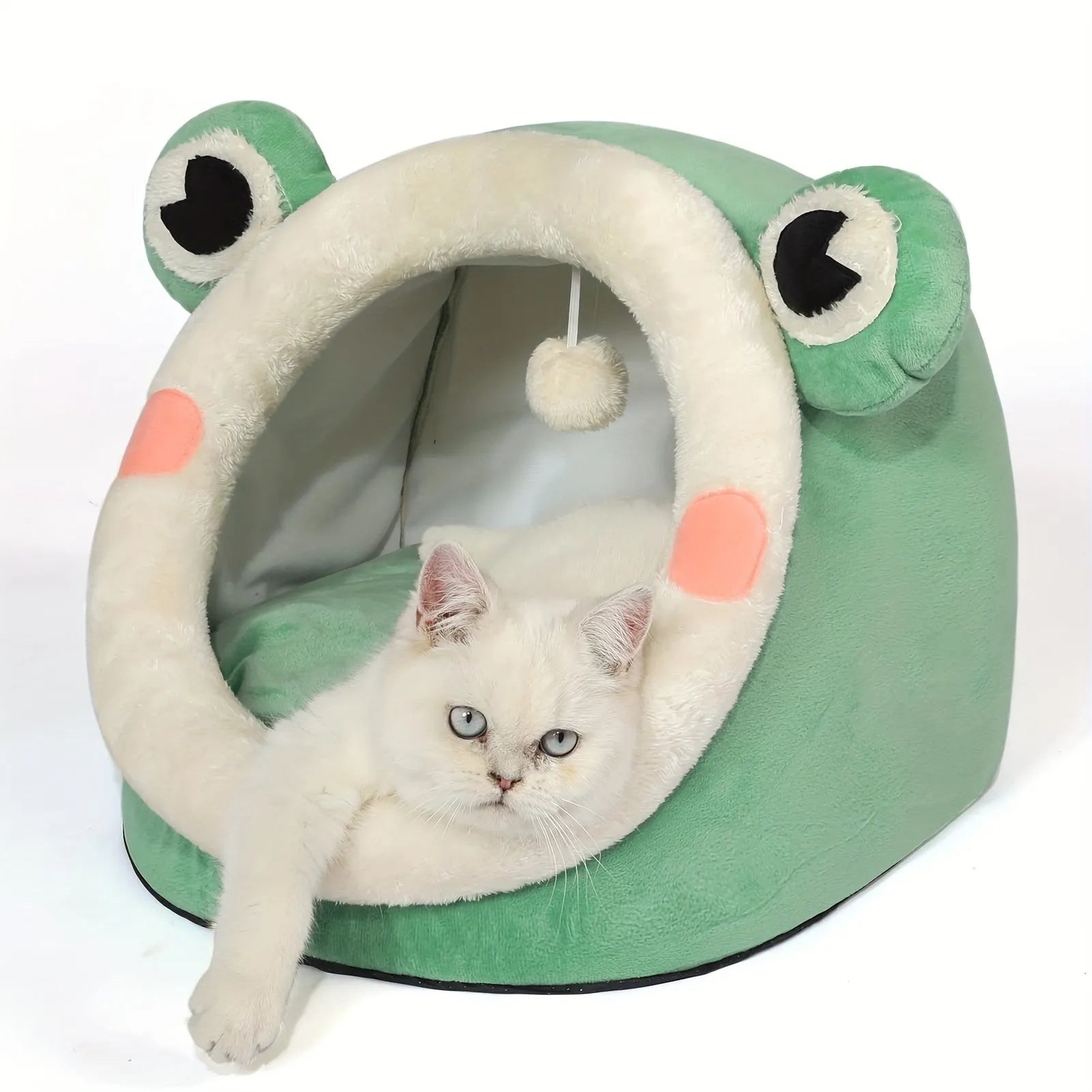 A white cat lounging inside green frog-shaped best bedding for cats.