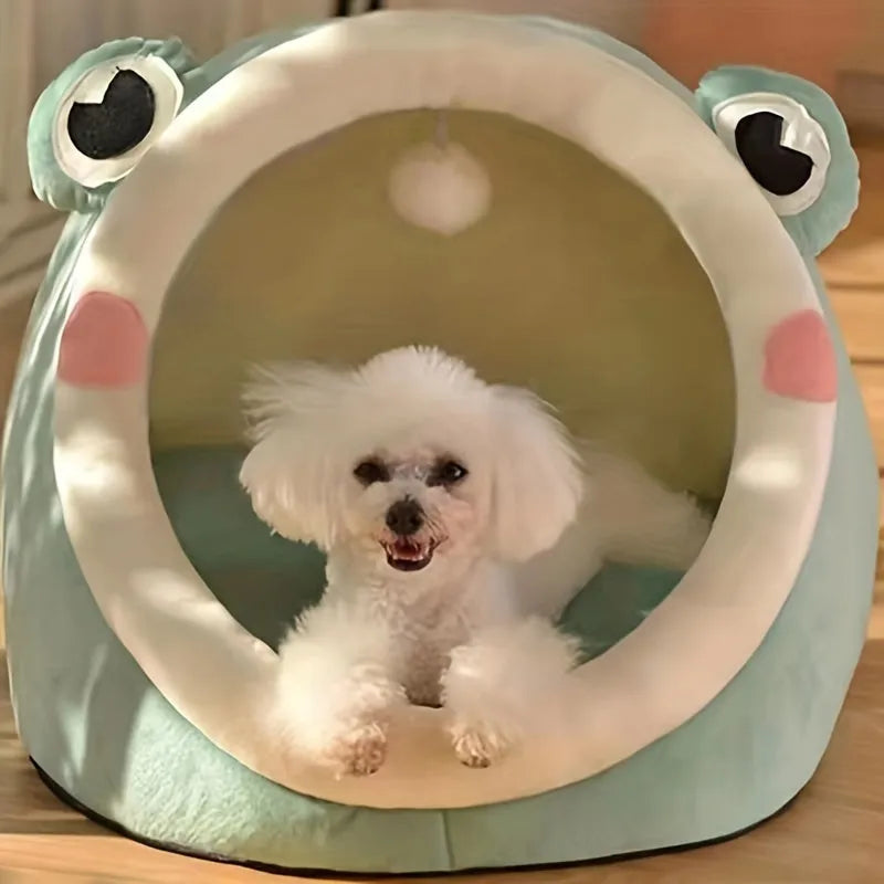 Green frog-shaped bedding for cats with a small white dog relaxing inside