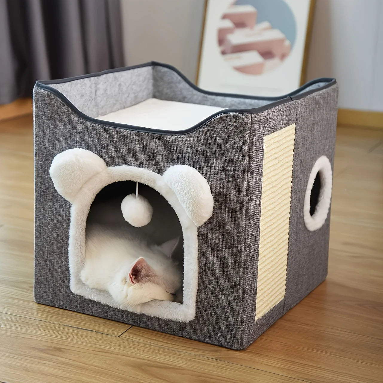 Cozy design of the best outdoor cat house featuring a soft interior and playful hanging toy.