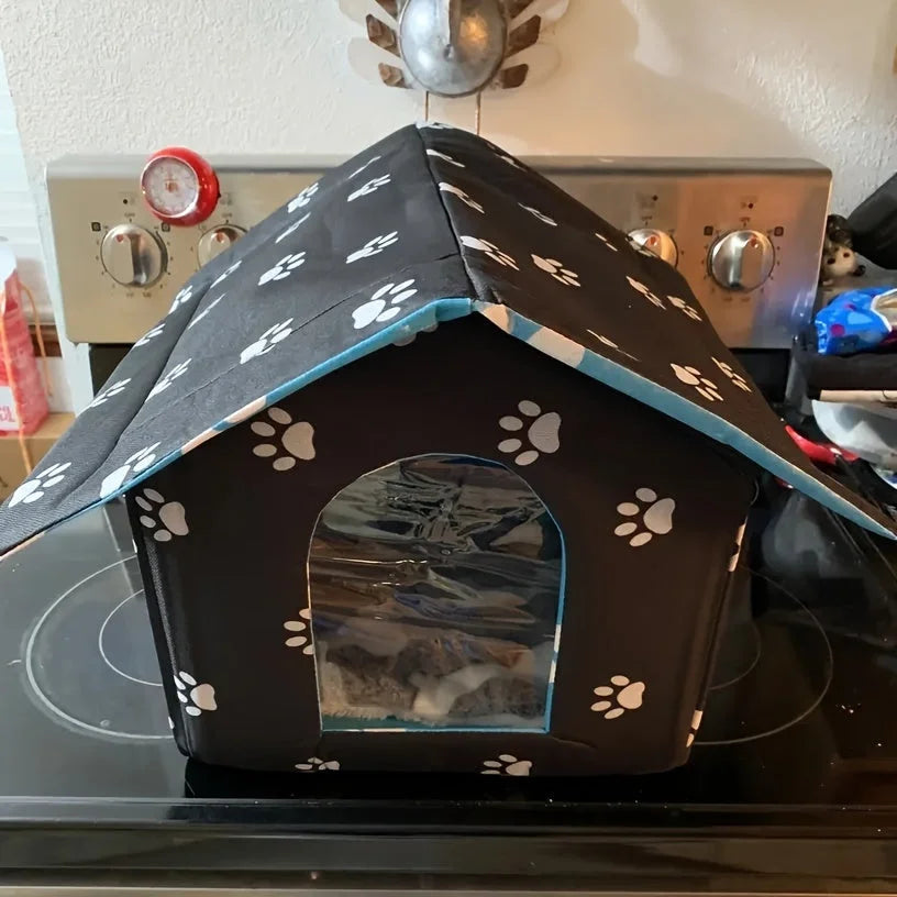 Best outdoor and indoor cat house for winter displayed on a kitchen countertop, showing its portable and compact structure.