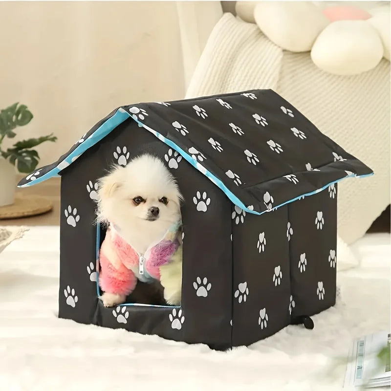 Black paw-print design of the best outdoor cat house for winter with a cat inside, set up indoor.