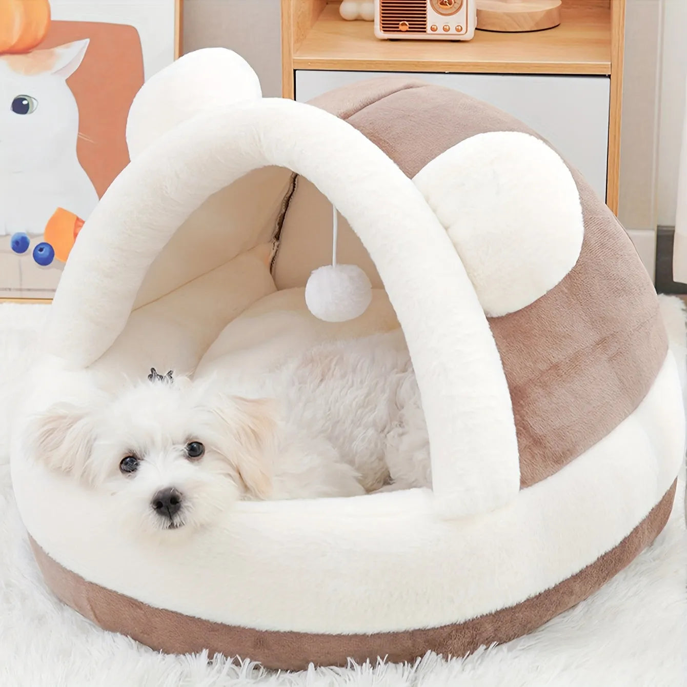 Plush brown dome-shaped best rated cat bed with a soft white lining and a dangling toy for added pet comfort and entertainment