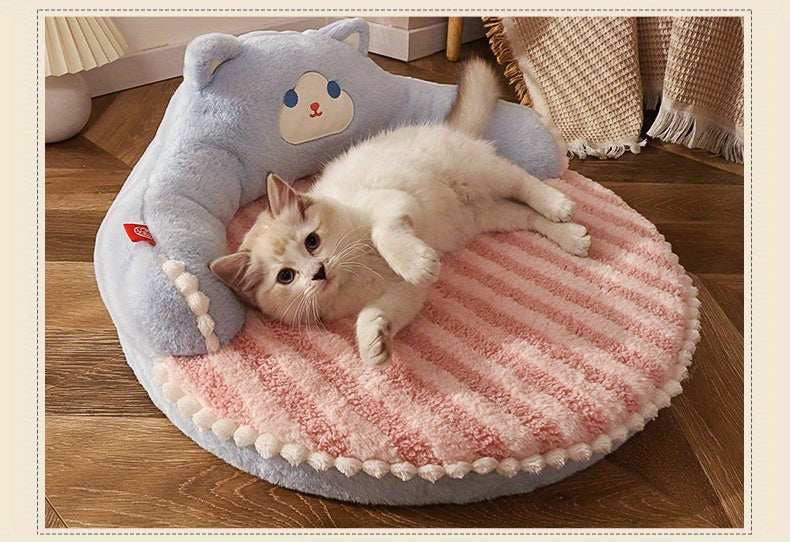 A cozy blue and pink cat bed with a plush teddy bear design and a fluffy white kitten lounging on it, ideal as an outdoor cat bed.