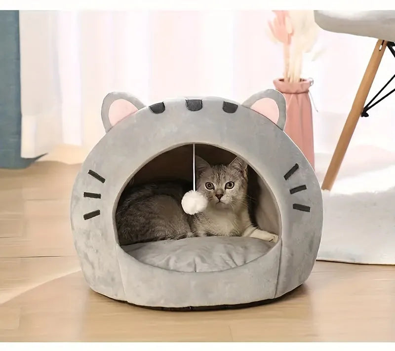 Modern-looking gray cat bed warmer with cute ears and a plush ball, perfect for providing warmth and comfort to cats