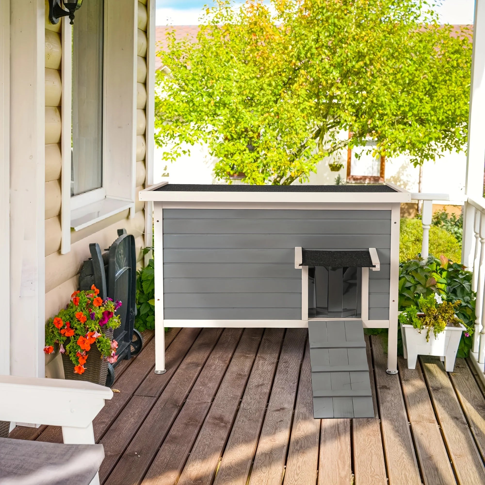 Stylish and functional outdoor cat house placed on a green lawn with a ramp and PVC door strip.