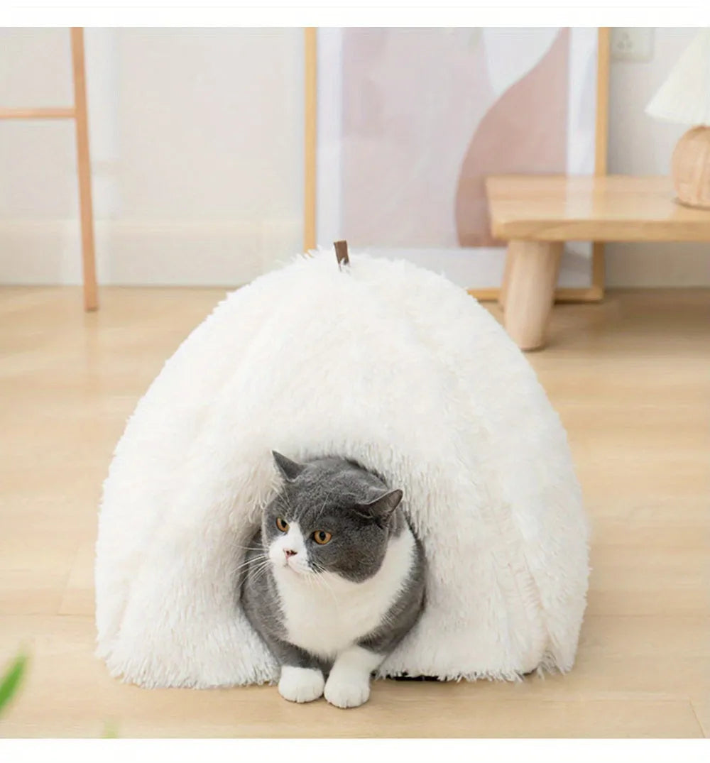 Cat resting in a white heated bed, a warm and snug retreat for pets during cold weather.