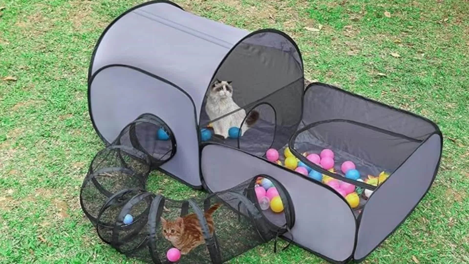 Outdoor cat playpen with tunnel, featuring mesh design and colorful balls for interactive play.