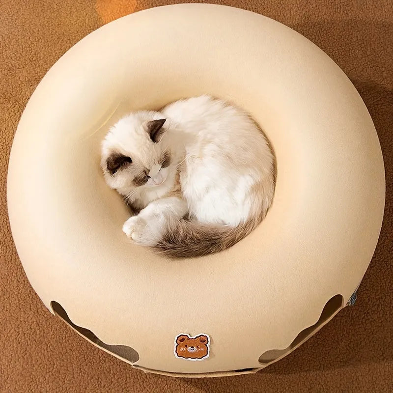 Top view of a cat comfortably sleeping on the circular cat tunnel bed, showcasing its plush and soft design.