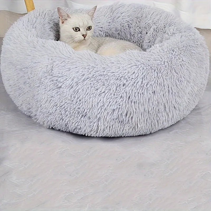 A white cat comfortably resting in a cozy, grey fluffy cat bed. Perfect for providing warmth and comfort to your pet. Cute Cat Beds for your feline.