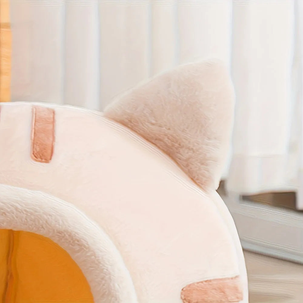 Close-up of the peach-colored Good Cat Bed showing its soft fabric and adorable ear details.