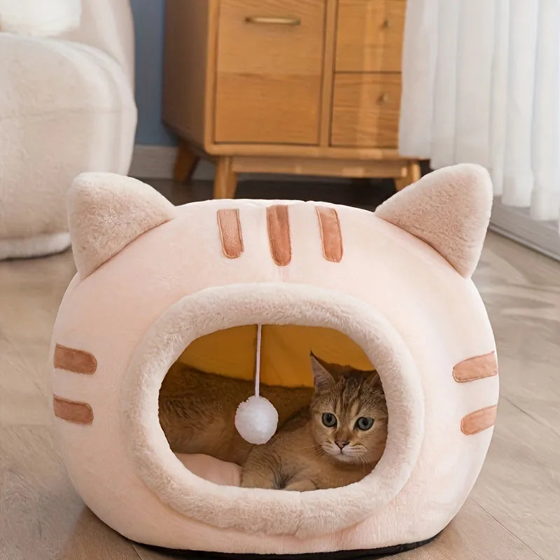 Peach-colored Good Cat Bed with a cozy interior and playful hanging ball.