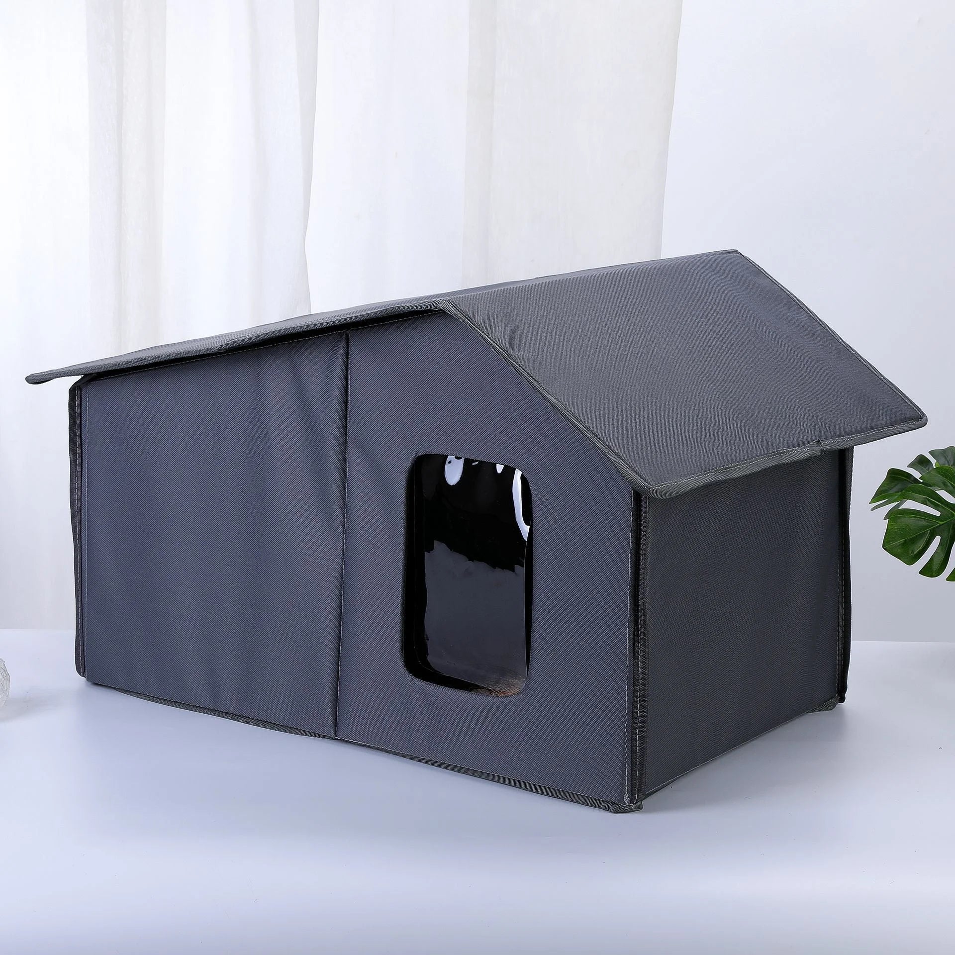 Gray collapsible top-rated outdoor cat house with a spacious and protective design.