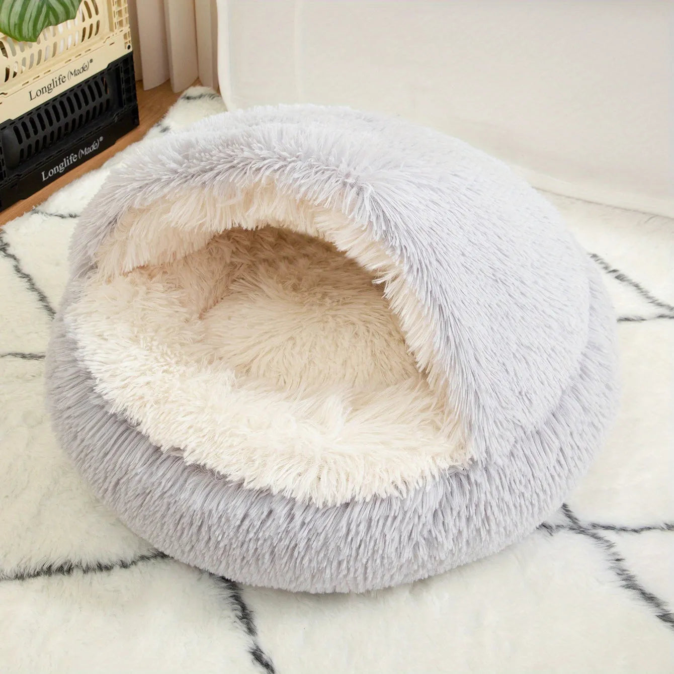 A cozy gray self-heating cat bed placed in a modern room, featuring a warm and inviting design.