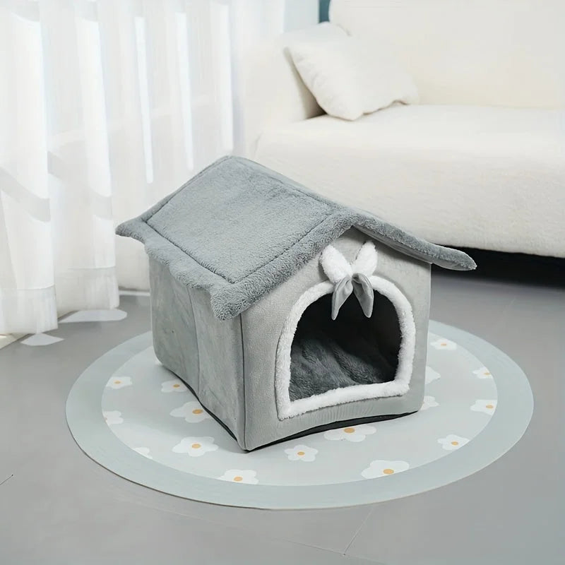 Gray indoor heated cat house with a bow accent and a soft interior for cats.