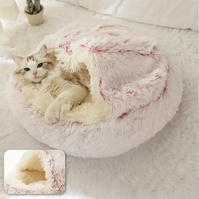 A soft pink plush cat bed offering a hideaway feature, perfect for keeping cats warm and comfortable.