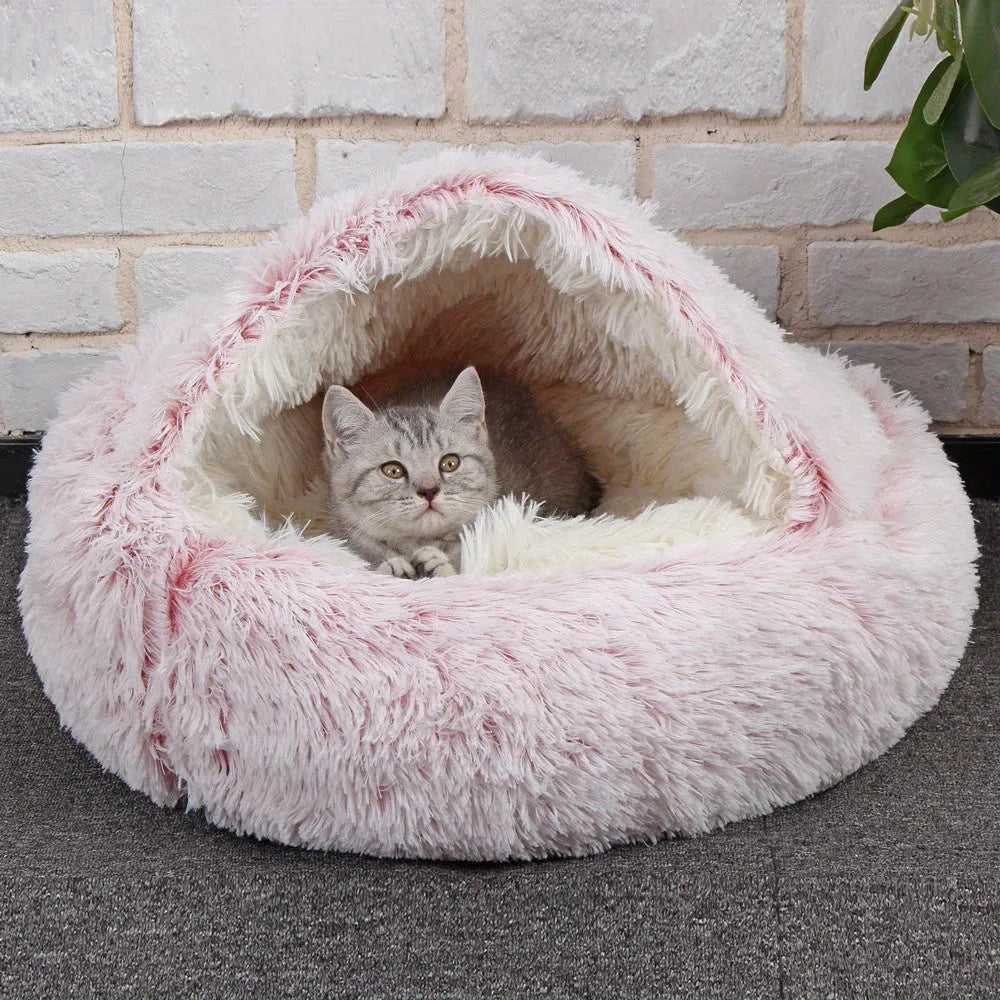 A luxurious pink cat bed with soft fur, ideal for a comfortable and stylish resting space.