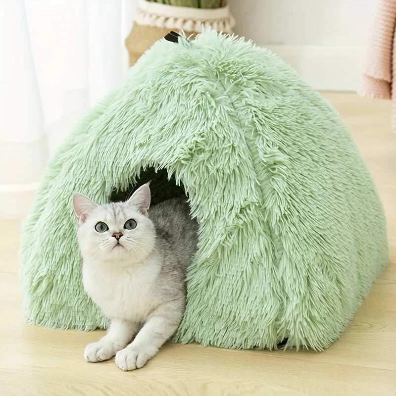 Green plush cat heated bed with a cat resting inside, showcasing a soft and inviting sleeping space.