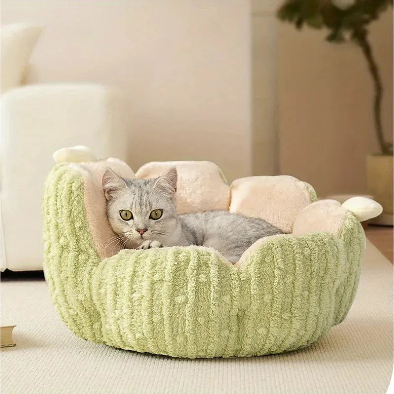 A grey cat relaxing in a plush green round cat bed, perfect bedding for cats to ensure comfort and warmth