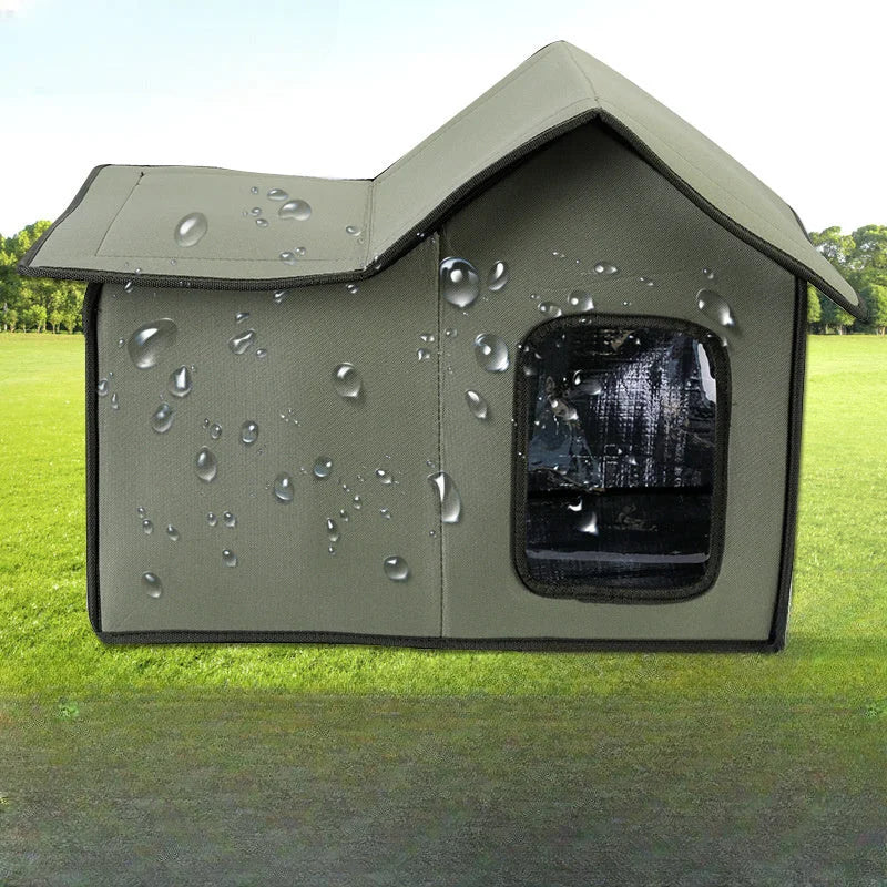 Green waterproof stray cat house for outdoor use on grass with rain protection