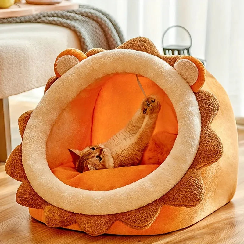 Cat playing with a toy inside a lion-shaped heated cat bed.