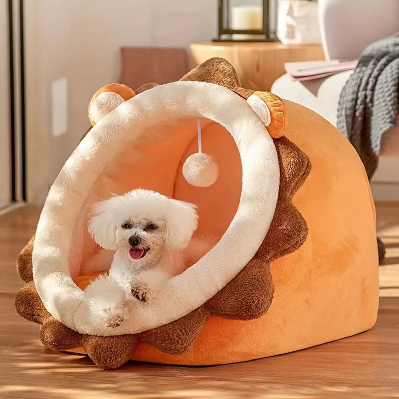 A dog peeking out from inside a heated cat bed with a lion design.