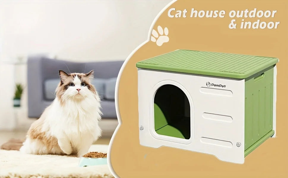 Indoor and outdoor plastic cat house with a green roof and a cat sitting nearby