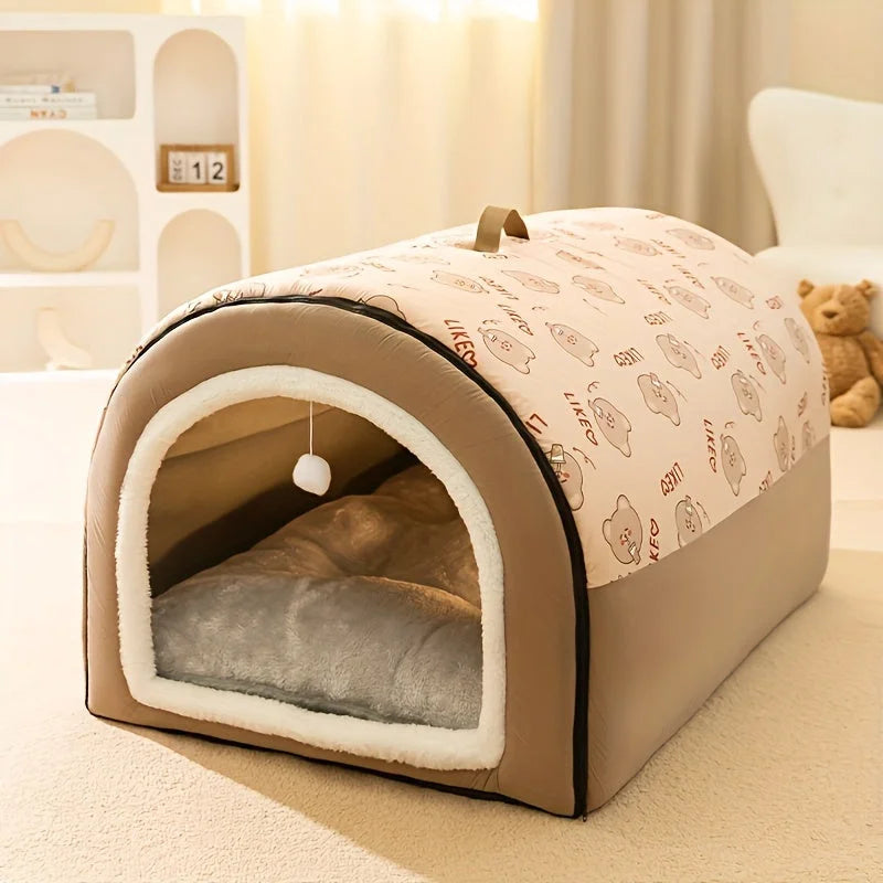 Brown insulated heated cat house with a cozy fleece lining and a hanging toy for playful cats.