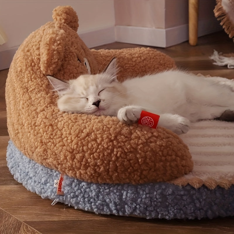 A white kitten peacefully napping on a cozy brown teddy bear-inspired cat bed, great for outdoor cat bed needs.