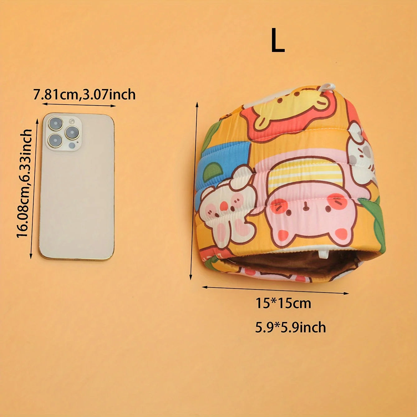 A colorful tote bag with cartoon animals is placed next to a smartphone for size comparison. 