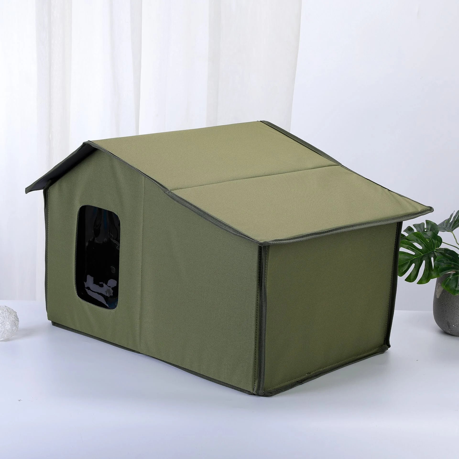 Olive green top-rated outdoor cat house with durable and spacious design for cats.