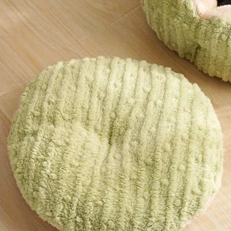 Removable round cushion of a soft green cat bed, designed as premium bedding for cats