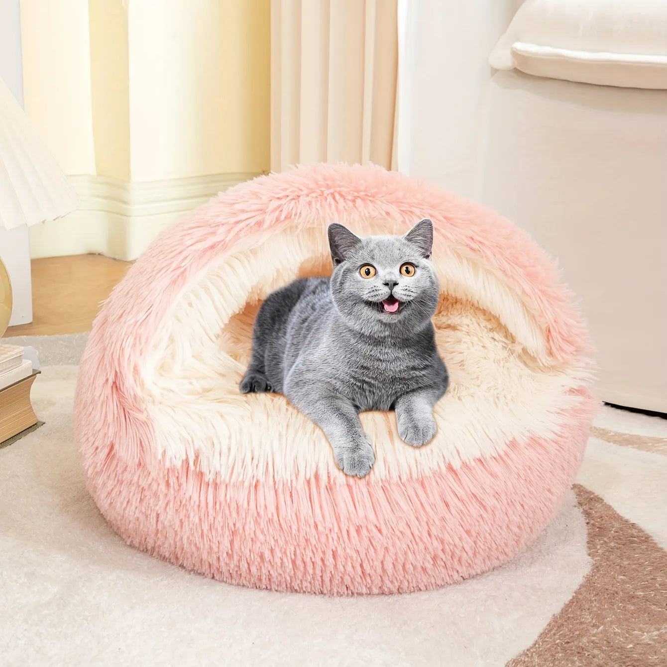 A happy gray cat sitting in a pink self-heating cat bed, designed for warmth and comfort.