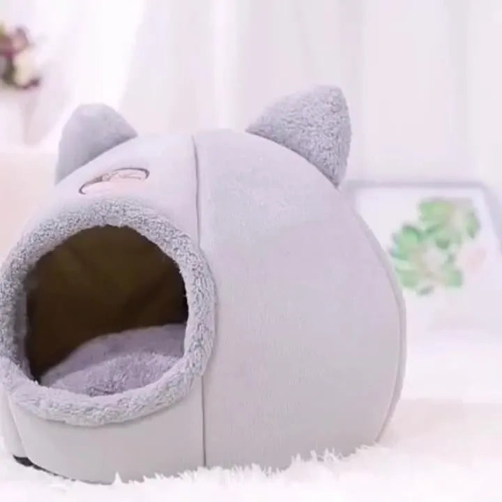 A stylish gray indoor heated cat bed with a cozy design, perfect for keeping cats warm and comfortable.