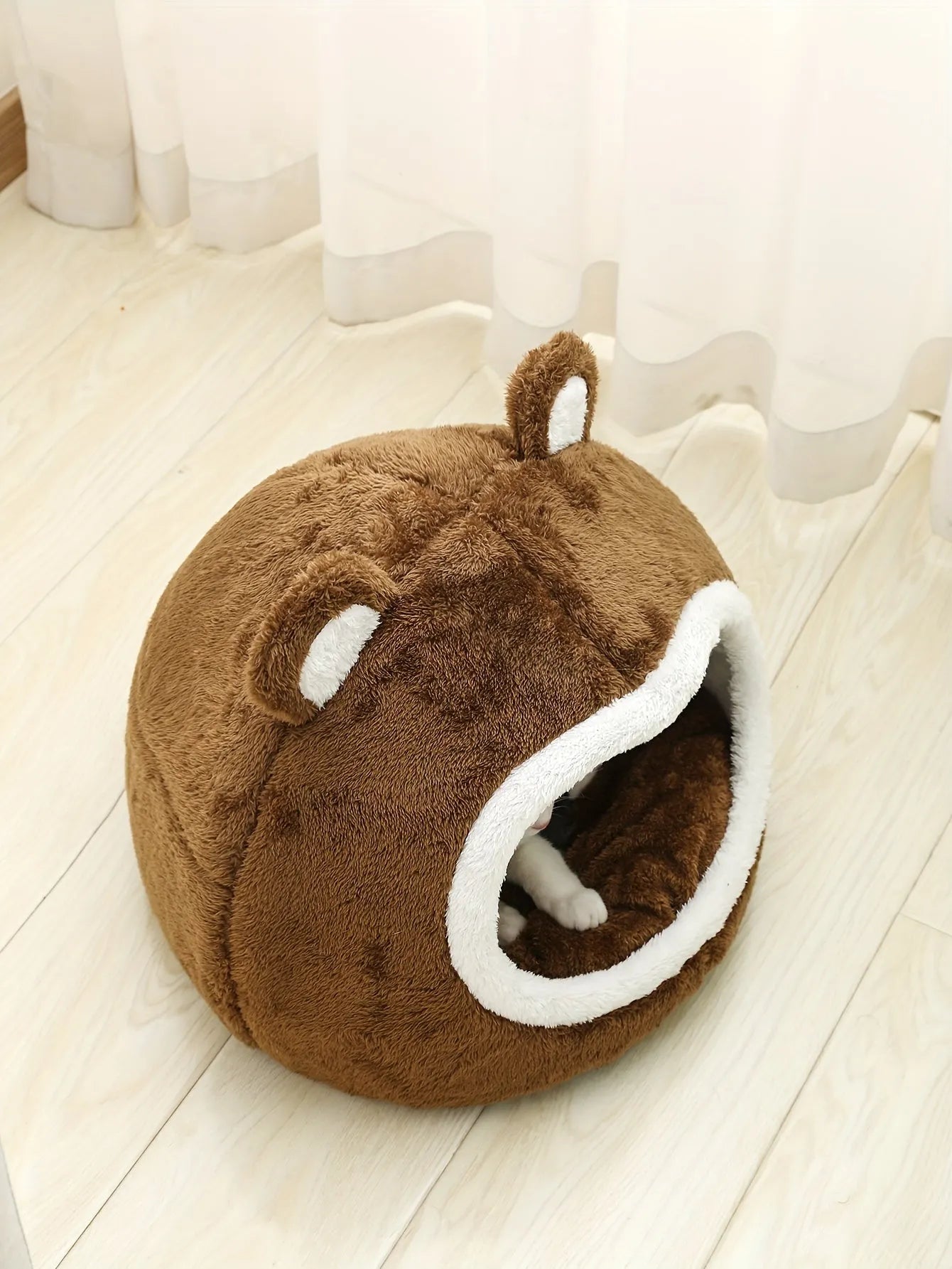 Top view of a warm cat bed with a bear design and plush material.